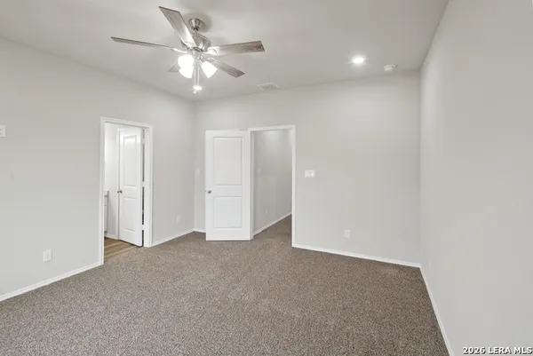 an empty room with fan and a ceiling fan
