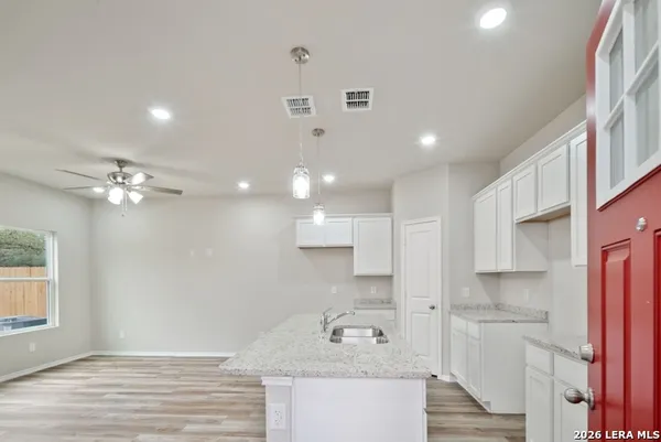 a bathroom with a sink double vanity granite and a shower