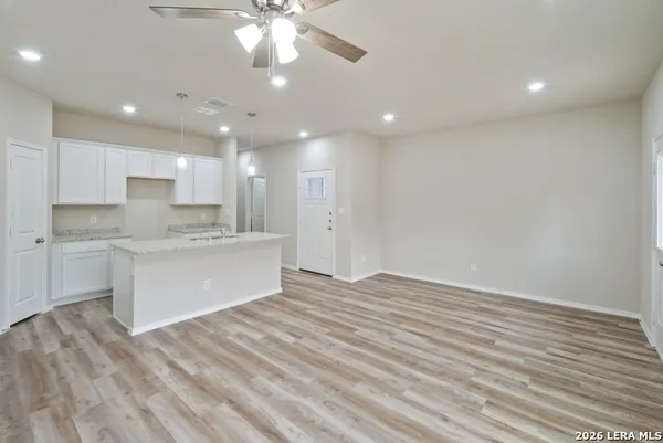 a view of kitchen with granite countertop cabinets and wooden floor
