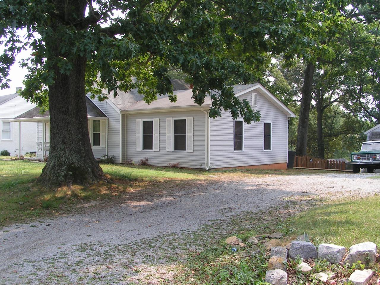 4351 Rakes Road Roanoke, VA 24014 - Photo 5 of 5 a backyard of a house with large trees and a small barn