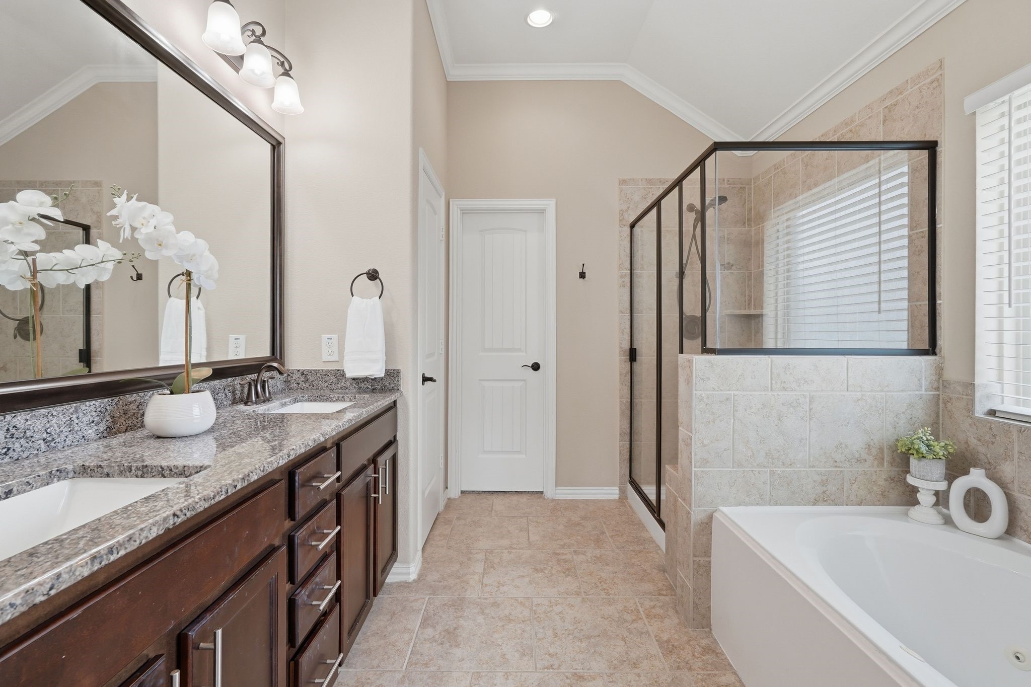 18227 Tacoma Ridge Drive Tomball, TX 77377 - Photo 23 of 45 Well-appointed primary bath featuring dual vanities, ample storage, and elegant finishes.