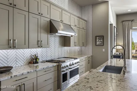 a kitchen with stainless steel appliances granite countertop a sink stove and cabinets