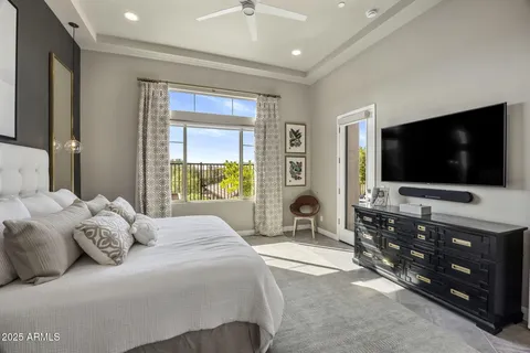 a bedroom with a flat screen television and a bed