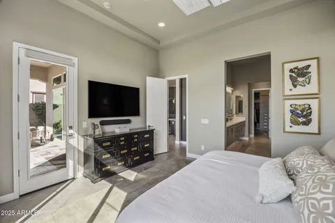a bedroom with furniture and flat screen tv