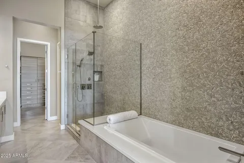 a bathroom with a bathtub and shower