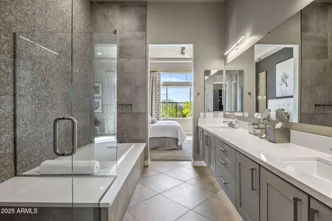 a spacious bathroom with a double vanity sink a mirror and shower