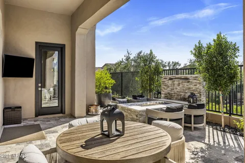 a dining room with couches chairs and a potted plant