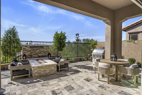 a view of a patio with couches table and chairs and potted plants