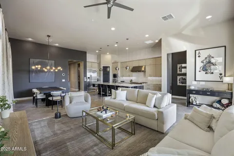 a living room with furniture kitchen view and a table