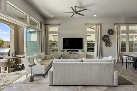 a living room with furniture wooden floor and a flat screen tv