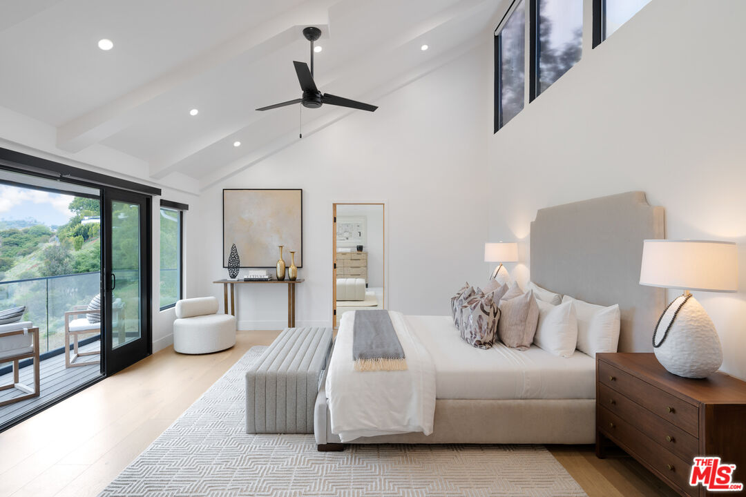 9645 Highridge Drive Beverly Hills, CA 90210 - Photo 13 of 29 a bedroom with furniture and large window