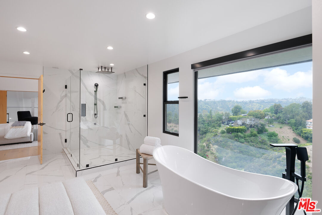 9645 Highridge Drive Beverly Hills, CA 90210 - Photo 16 of 29 a bathroom with a bathtub and a shower