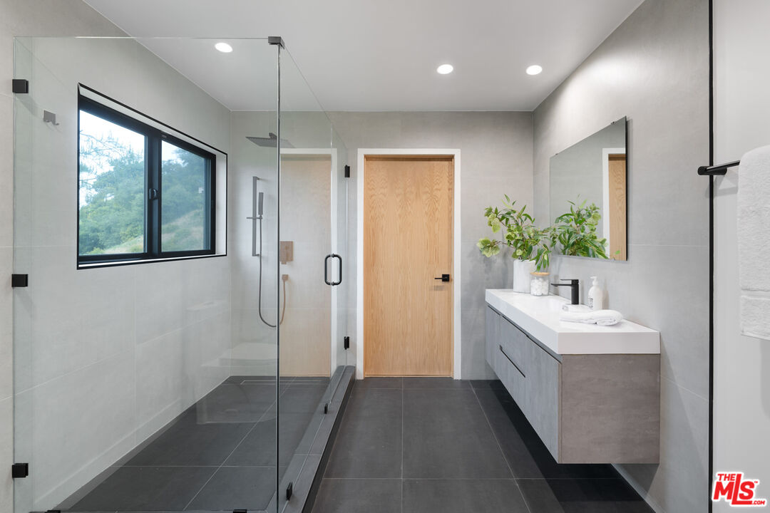 9645 Highridge Drive Beverly Hills, CA 90210 - Photo 20 of 29 a bathroom with a sink and a mirror