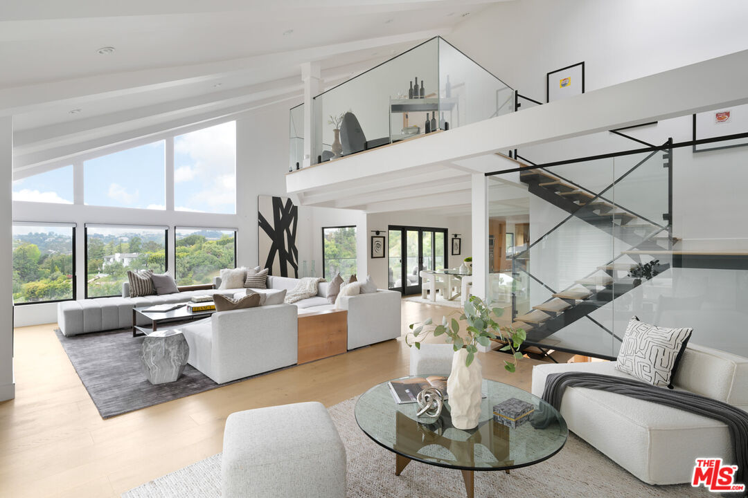 9645 Highridge Drive Beverly Hills, CA 90210 - Photo 2 of 29 a living room with furniture large window and dining table