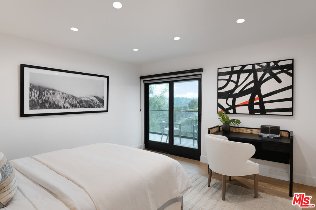 9645 Highridge Drive Beverly Hills, CA 90210 - Photo 21 of 29 a bedroom with a bed and a painting on the wall