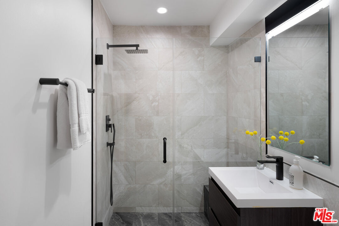 9645 Highridge Drive Beverly Hills, CA 90210 - Photo 22 of 29 a bathroom with a sink and a mirror
