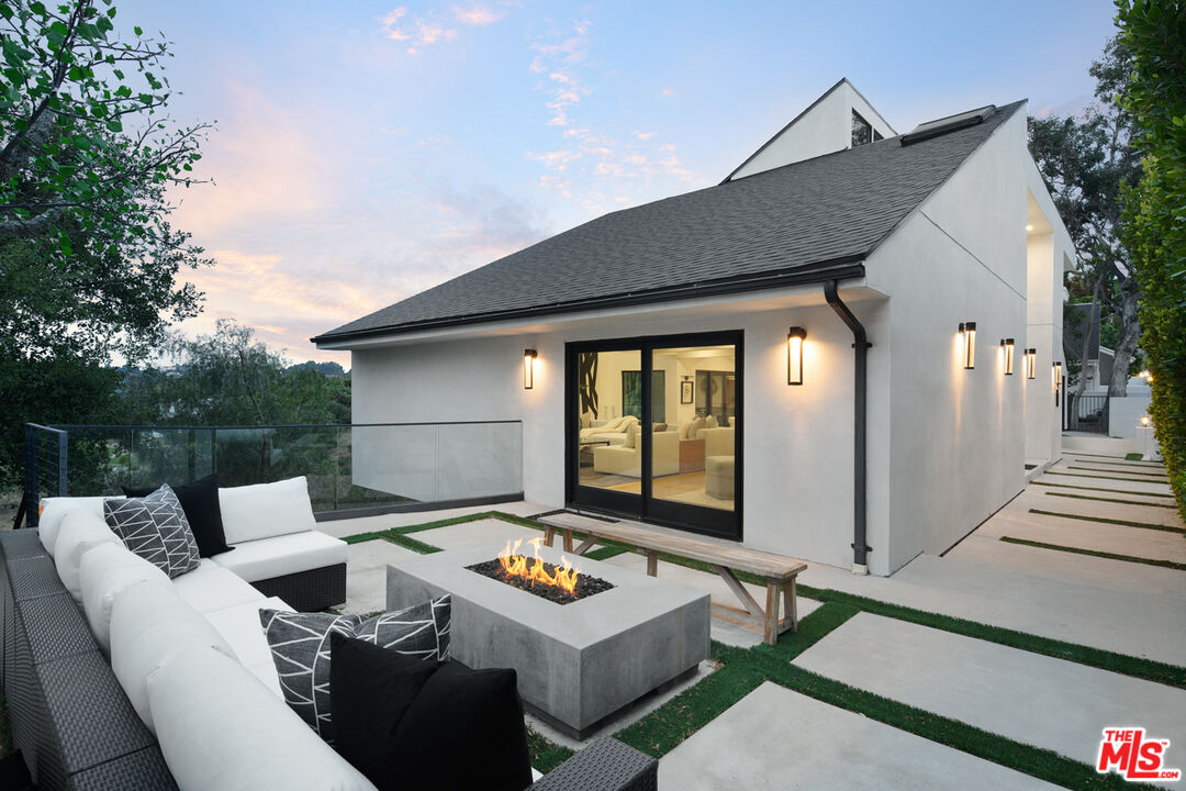 9645 Highridge Drive Beverly Hills, CA 90210 - Photo 24 of 29 a front view of a house with a yard