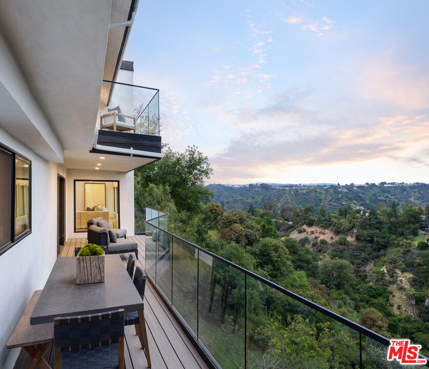 9645 Highridge Drive Beverly Hills, CA 90210 - Photo 7 of 29 a view of a balcony with furniture