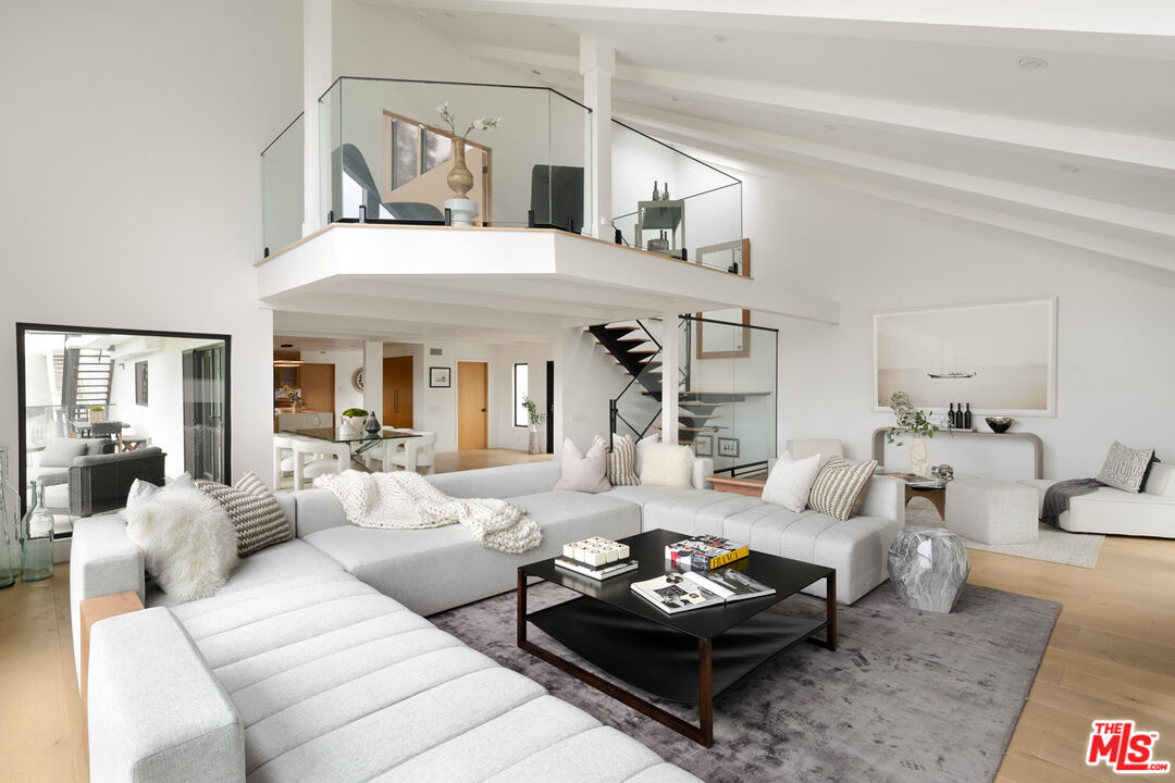 9645 Highridge Drive Beverly Hills, CA 90210 - Photo 9 of 29 a living room with furniture couches and a dining table with wooden floor