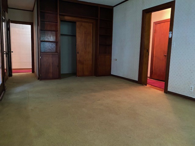 503 Main Street Garwood, TX 77442 - Photo 13 of 24 an empty room with closet and wooden door