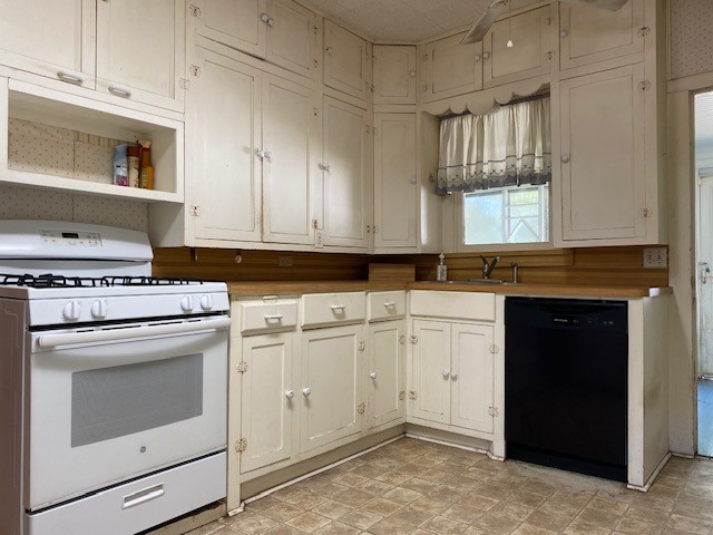 503 Main Street Garwood, TX 77442 - Photo 15 of 24 a kitchen with granite countertop white cabinets and white appliances