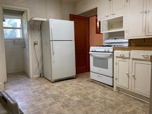503 Main Street Garwood, TX 77442 - Photo 16 of 24 a white refrigerator freezer and a stove sitting inside of a kitchen