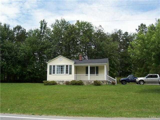 9801 Virgilina Road Roxboro, NC 27574 - Photo 1 of 2 a front view of a house with a yard