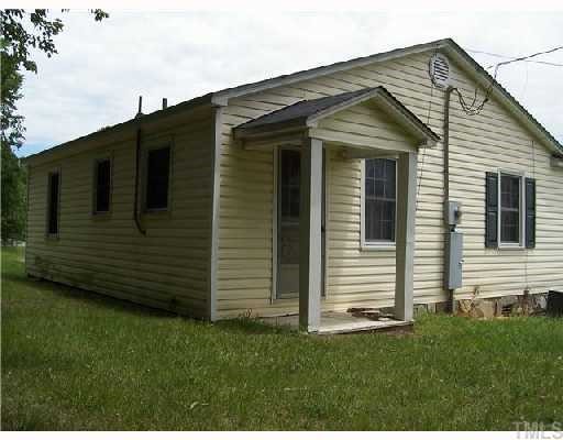 9801 Virgilina Road Roxboro, NC 27574 - Photo 2 of 2 a front view of a house with a yard