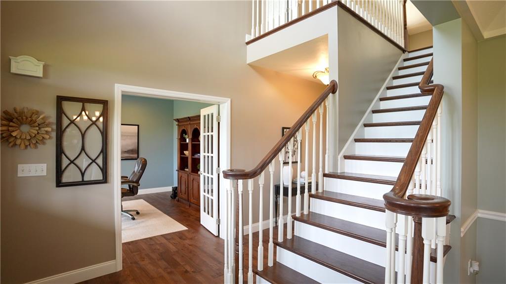 121 Stoney Springs Road Greensburg, PA 15601 - Photo 13 of 45 a view of staircase with lots of frames on wall and wooden floor