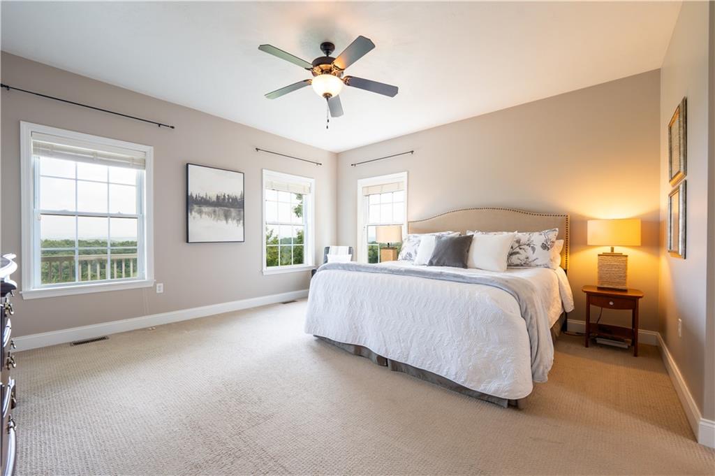 121 Stoney Springs Road Greensburg, PA 15601 - Photo 22 of 45 a bedroom with a large bed and a chandelier