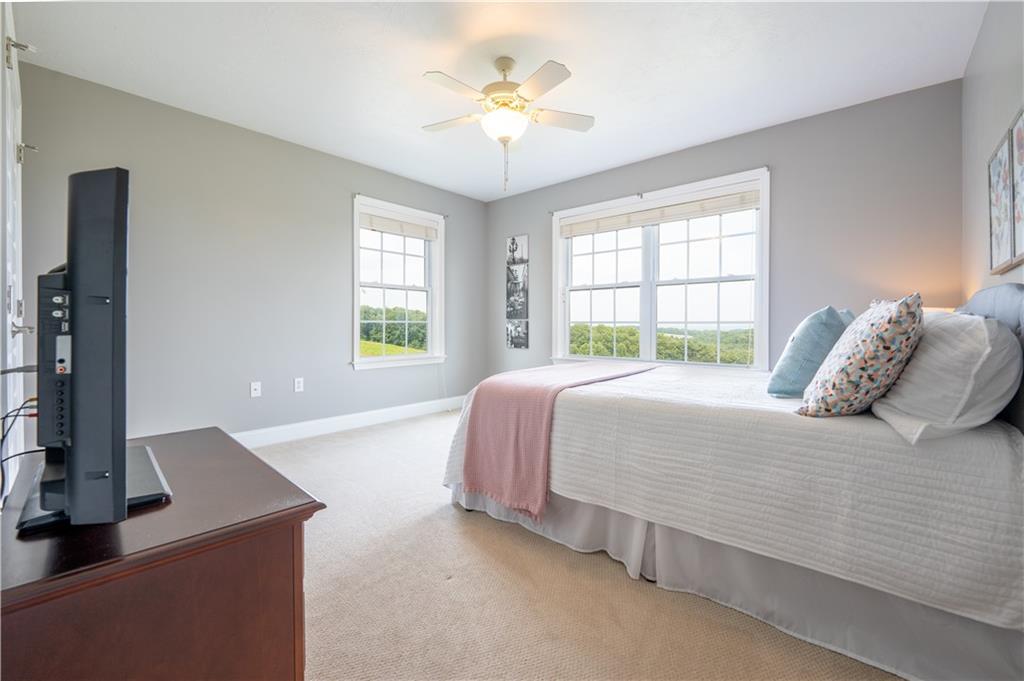 121 Stoney Springs Road Greensburg, PA 15601 - Photo 29 of 45 a bedroom with a bed and a chandelier