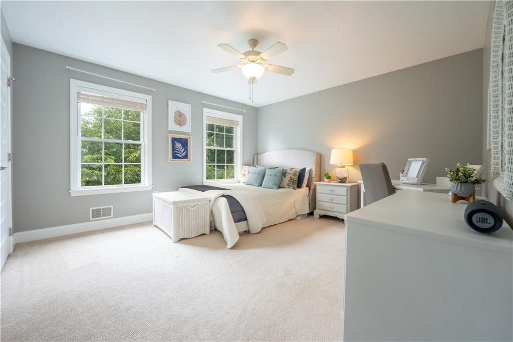 121 Stoney Springs Road Greensburg, PA 15601 - Photo 30 of 45 a spacious bedroom with a bed and a chandelier