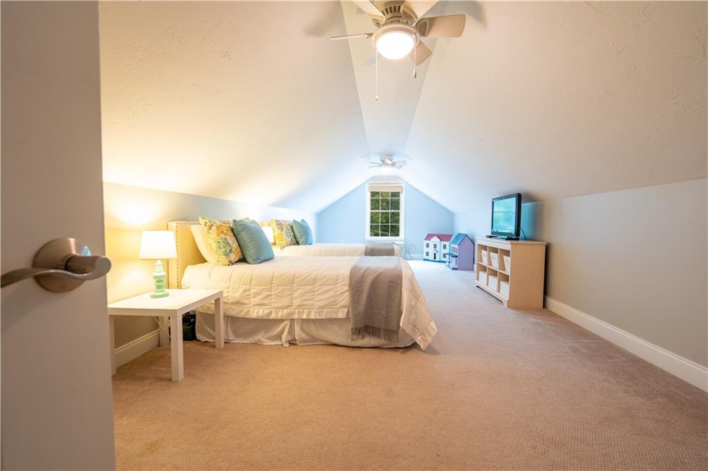 121 Stoney Springs Road Greensburg, PA 15601 - Photo 32 of 45 a bed room with a bed and a chandelier