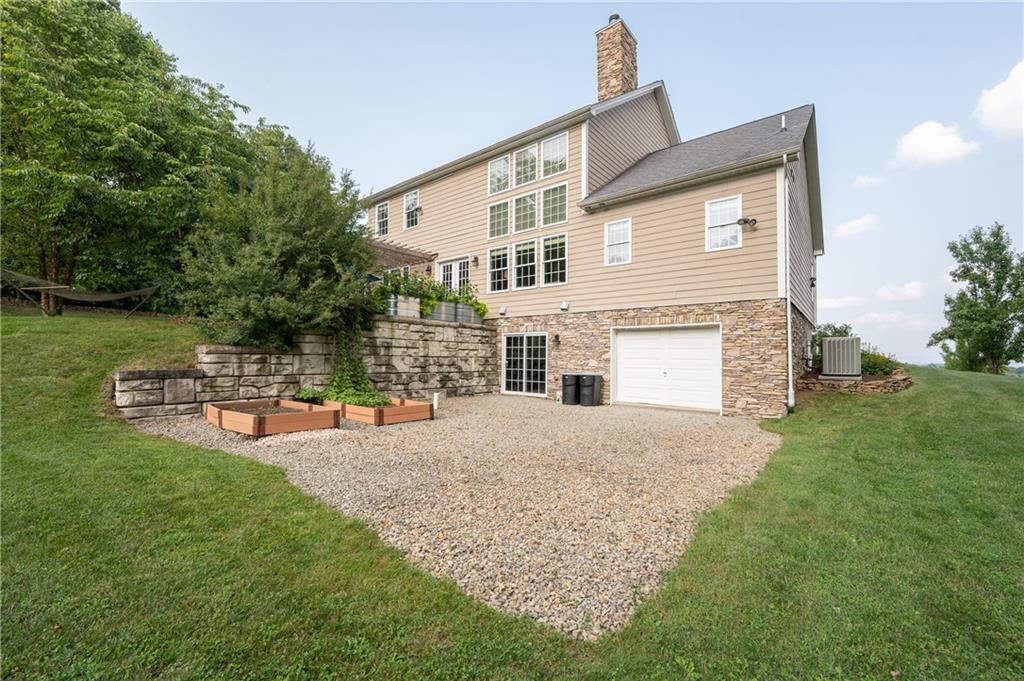 121 Stoney Springs Road Greensburg, PA 15601 - Photo 41 of 45 a front view of a house with sitting space and garden