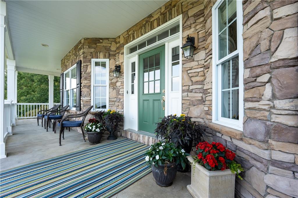 121 Stoney Springs Road Greensburg, PA 15601 - Photo 6 of 45 a view of a patio with chairs and potted plants