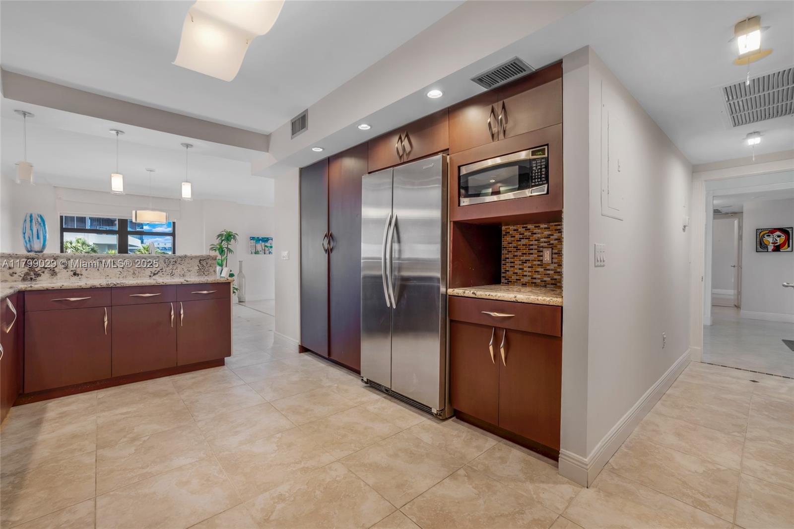 9801 Collins Avenue, Unit 5S Bal Harbour, FL 33154 - Photo 15 of 32 a kitchen with stainless steel appliances granite countertop a refrigerator and a sink