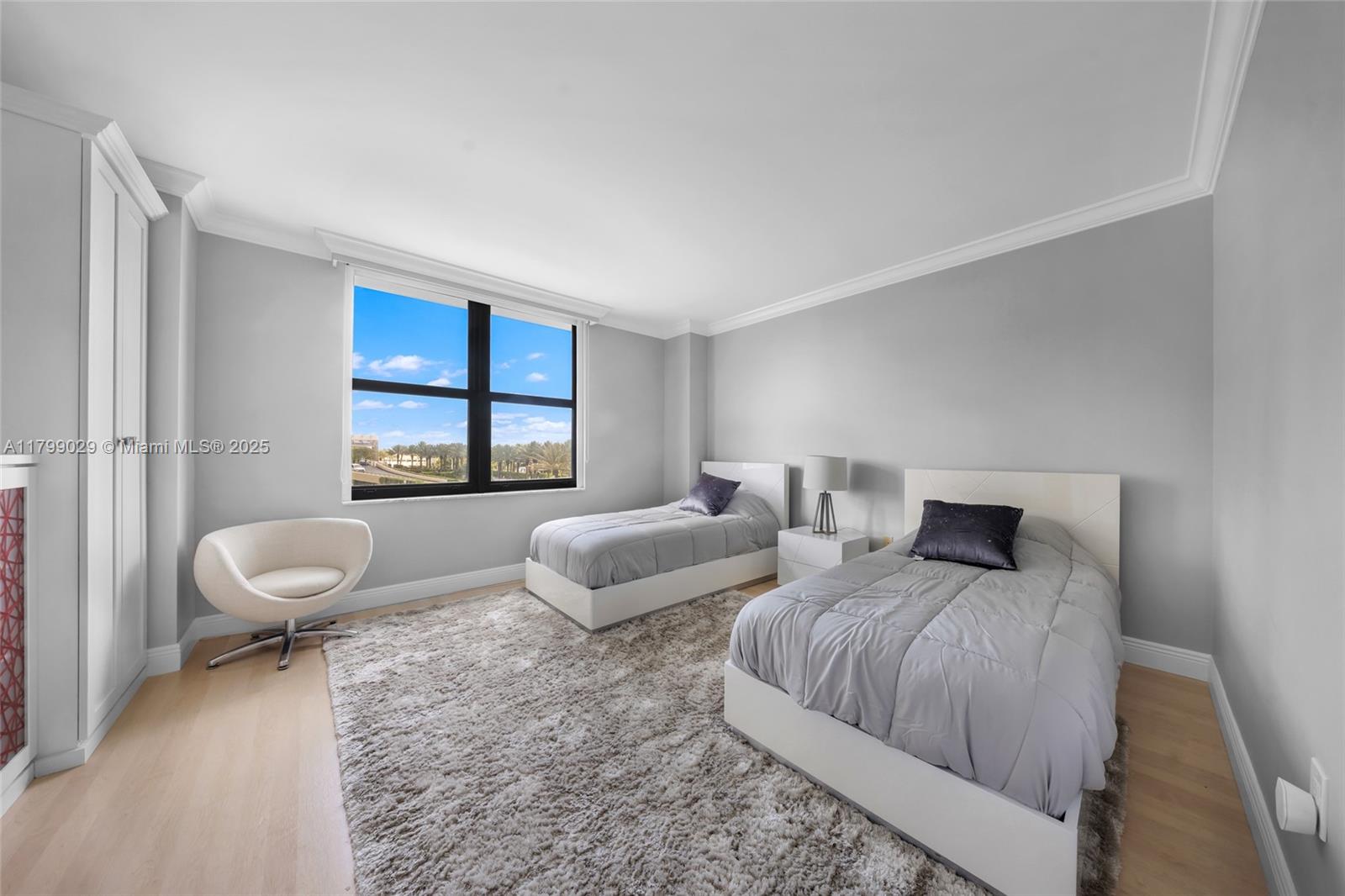 9801 Collins Avenue, Unit 5S Bal Harbour, FL 33154 - Photo 18 of 32 a bedroom with two beds and a large window