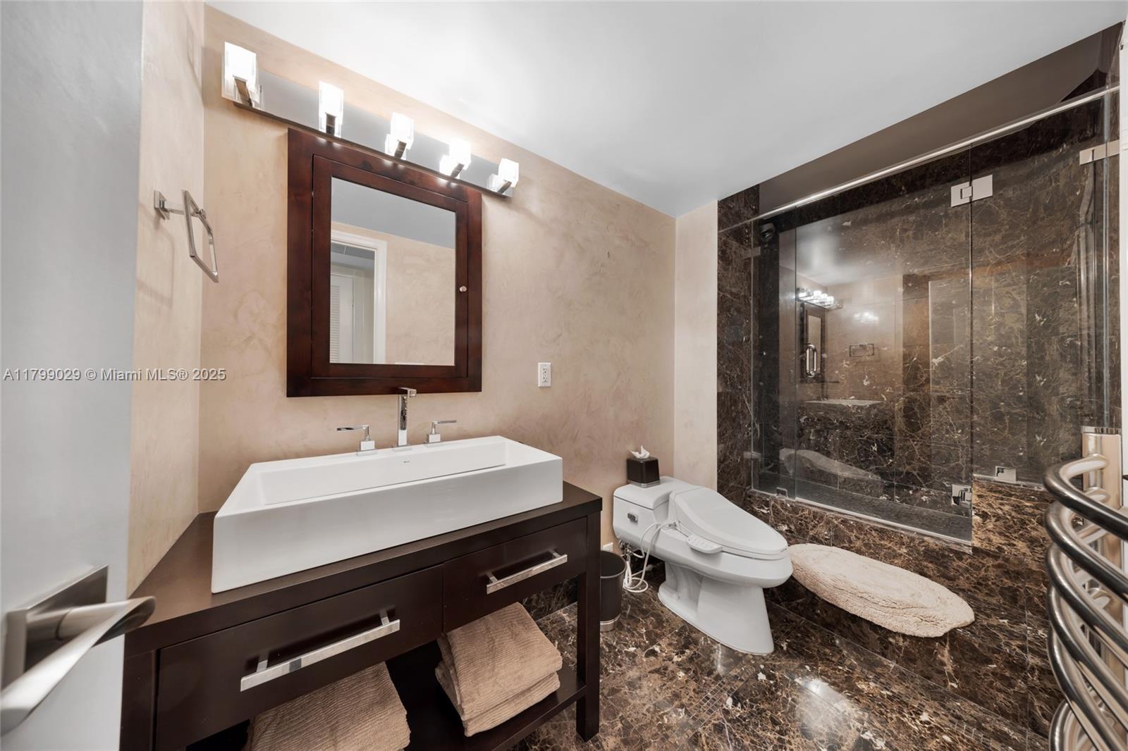9801 Collins Avenue, Unit 5S Bal Harbour, FL 33154 - Photo 21 of 32 a bathroom with a sink and a mirror
