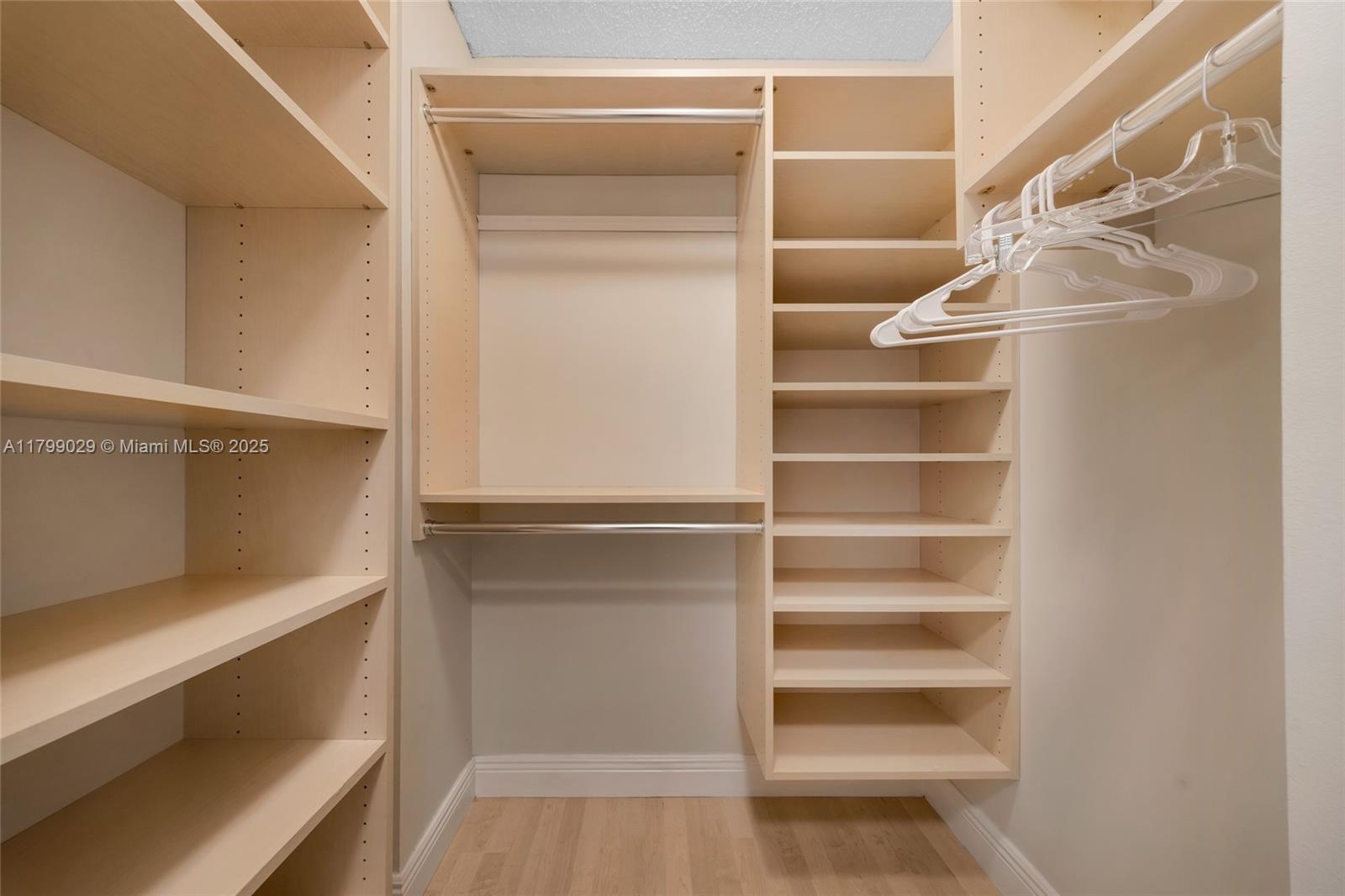 9801 Collins Avenue, Unit 5S Bal Harbour, FL 33154 - Photo 22 of 32 a view of walk in closet with empty racks