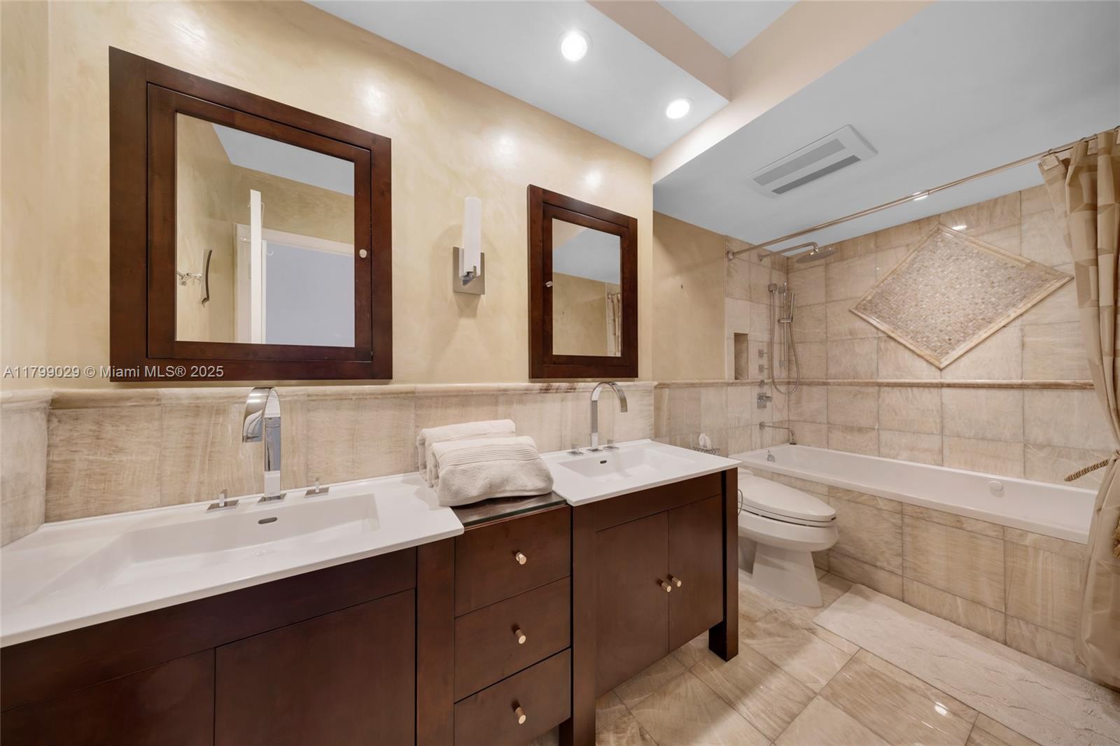 9801 Collins Avenue, Unit 5S Bal Harbour, FL 33154 - Photo 23 of 32 a bathroom with a double vanity sink and a mirror