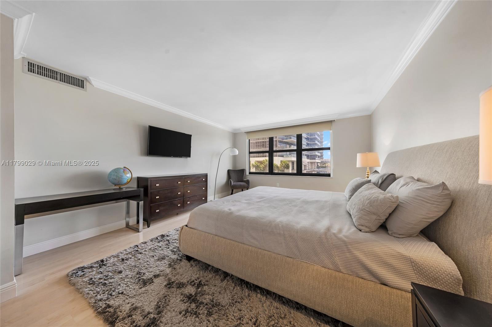 9801 Collins Avenue, Unit 5S Bal Harbour, FL 33154 - Photo 25 of 32 a bedroom with a large bed and a flat screen tv