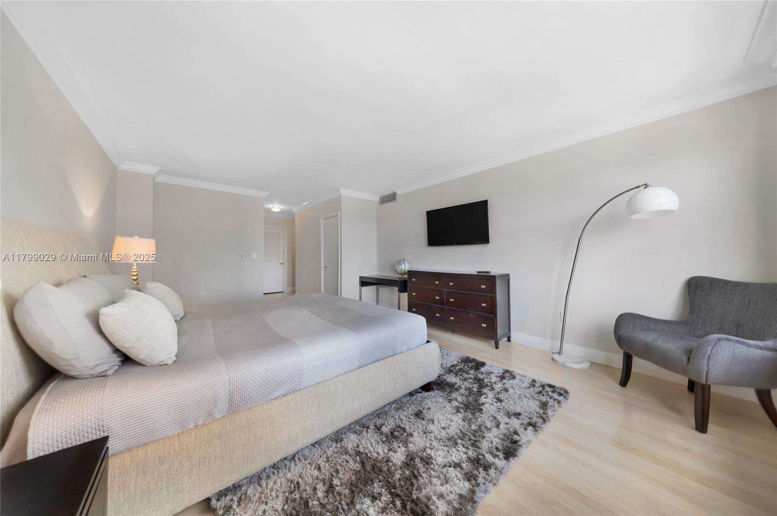 9801 Collins Avenue, Unit 5S Bal Harbour, FL 33154 - Photo 27 of 32 a bedroom with a bed and furniture