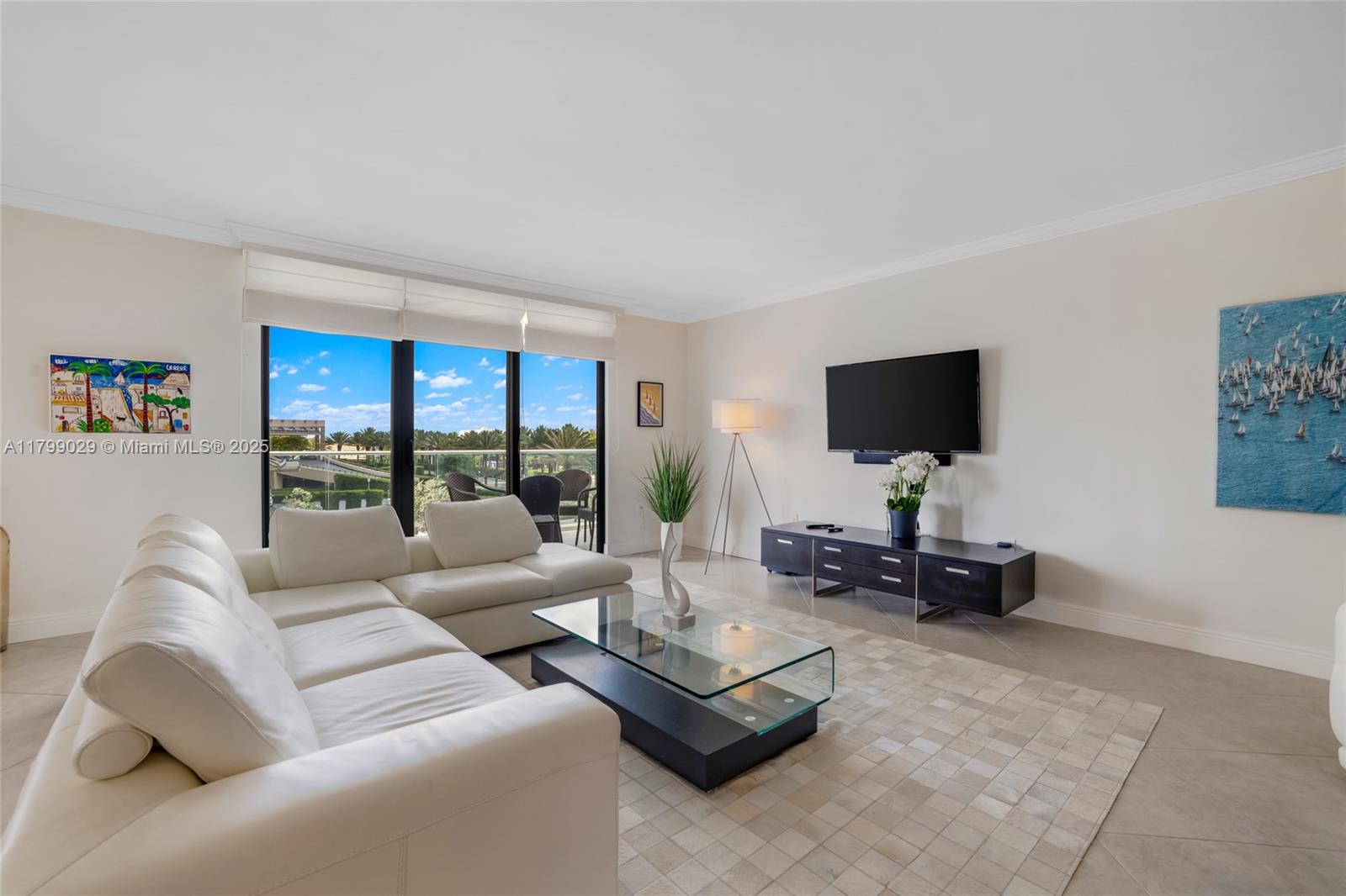 9801 Collins Avenue, Unit 5S Bal Harbour, FL 33154 - Photo 4 of 32 a living room with furniture and a flat screen tv