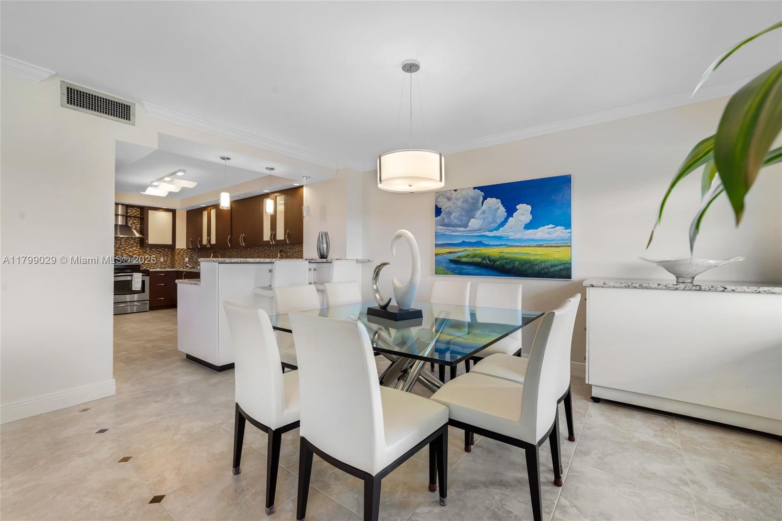 9801 Collins Avenue, Unit 5S Bal Harbour, FL 33154 - Photo 10 of 32 a view of kitchen with dining area and chandelier