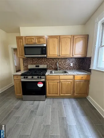 a kitchen with a stove a sink and a microwave