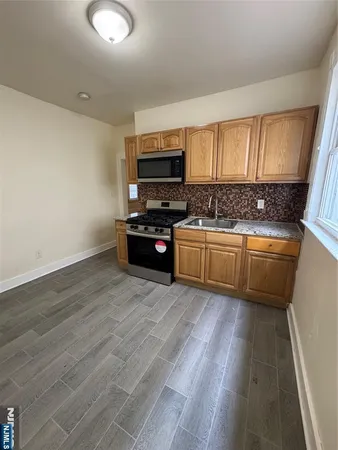 a kitchen with stainless steel appliances a stove a sink and a refrigerator
