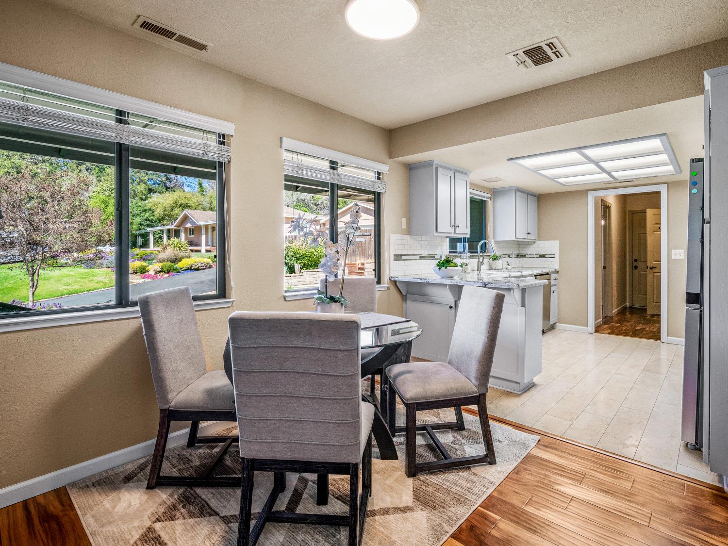 2401 Roxana Street Placerville, CA 95667 - Photo 11 of 45 a dining room with furniture a rug and wooden floor
