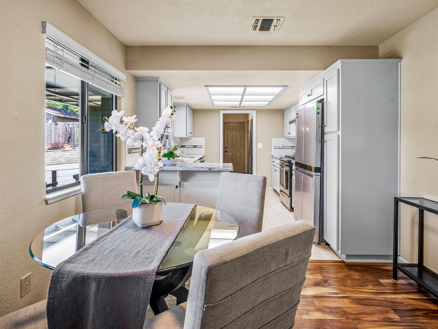 2401 Roxana Street Placerville, CA 95667 - Photo 12 of 45 a living room with furniture dining table and wooden floor