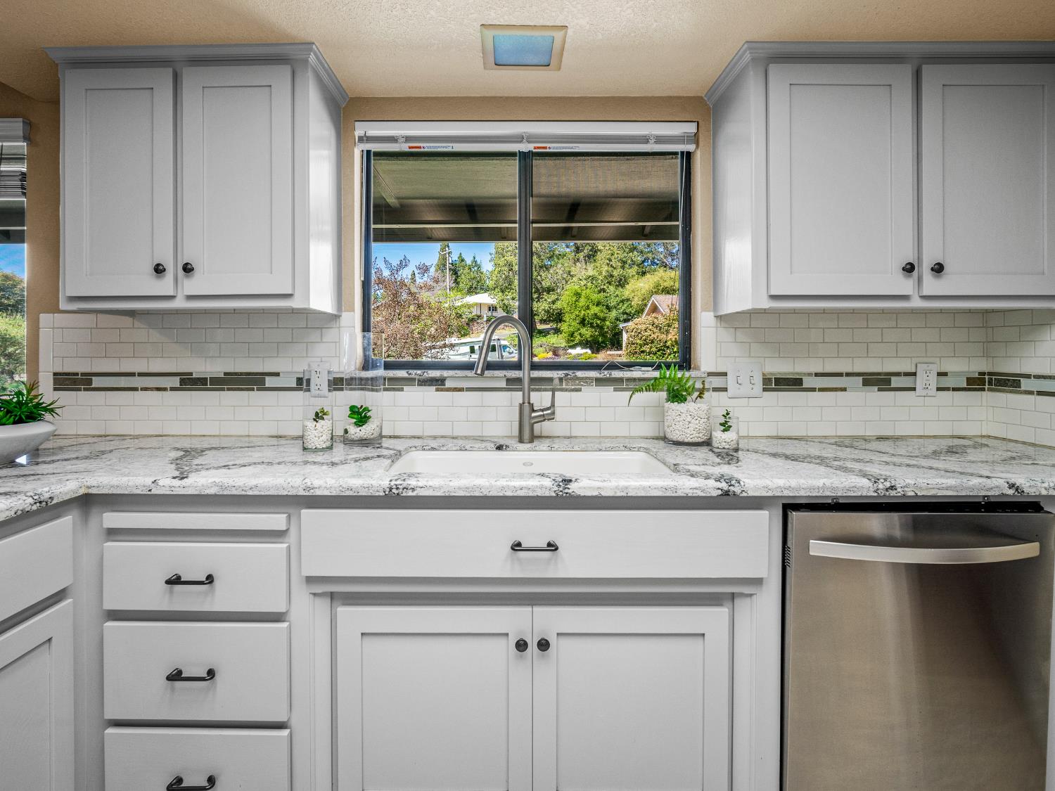 2401 Roxana Street Placerville, CA 95667 - Photo 14 of 45 a kitchen with granite countertop a sink and cabinets