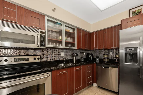 a kitchen with stainless steel appliances and cabinets